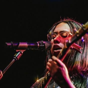Jensen McRae performing with a guitar at the El Rey Theatre in Los Angeles